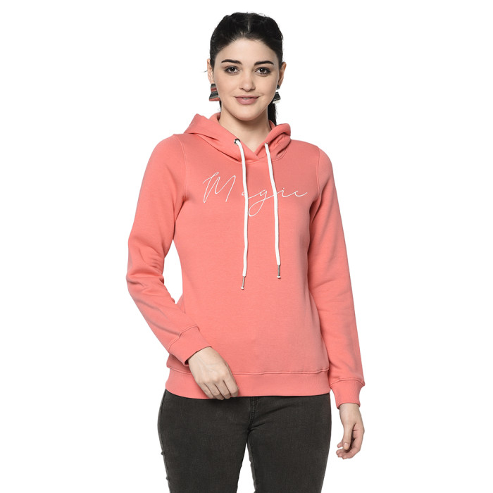 A woman wearing a Coral Pink Hoodie with ribbed cuff, drawstring and pocket in hand designed for mild winter.